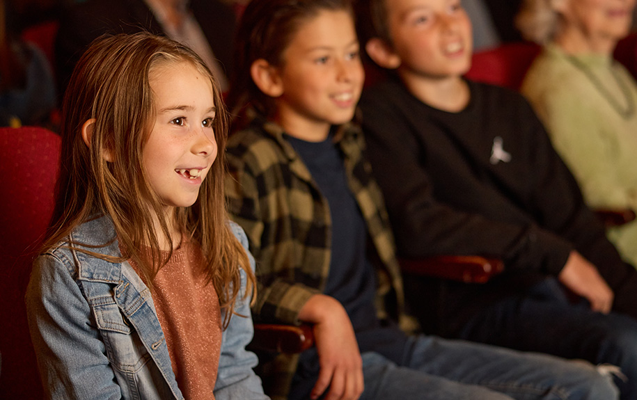 A young theatregoer enjoying a show in the Auditorium Theatre
