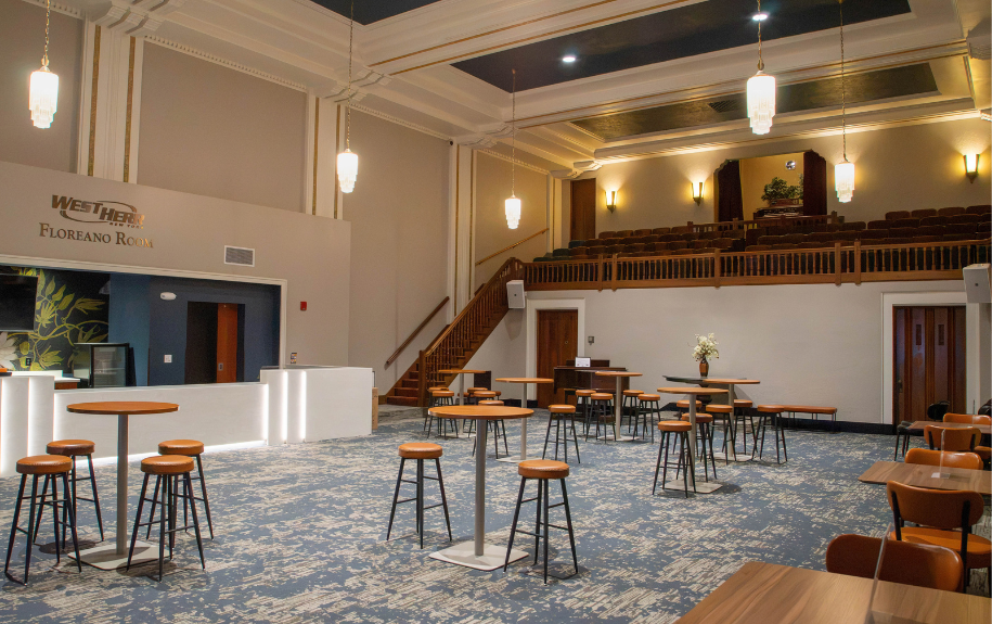 lounge with light wood high-top tables and stools.